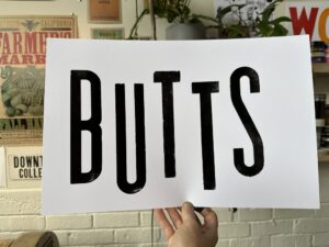 A sign that says BUTTS