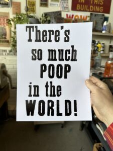 A sign that says "There's so much POOP in the WORLD!"
